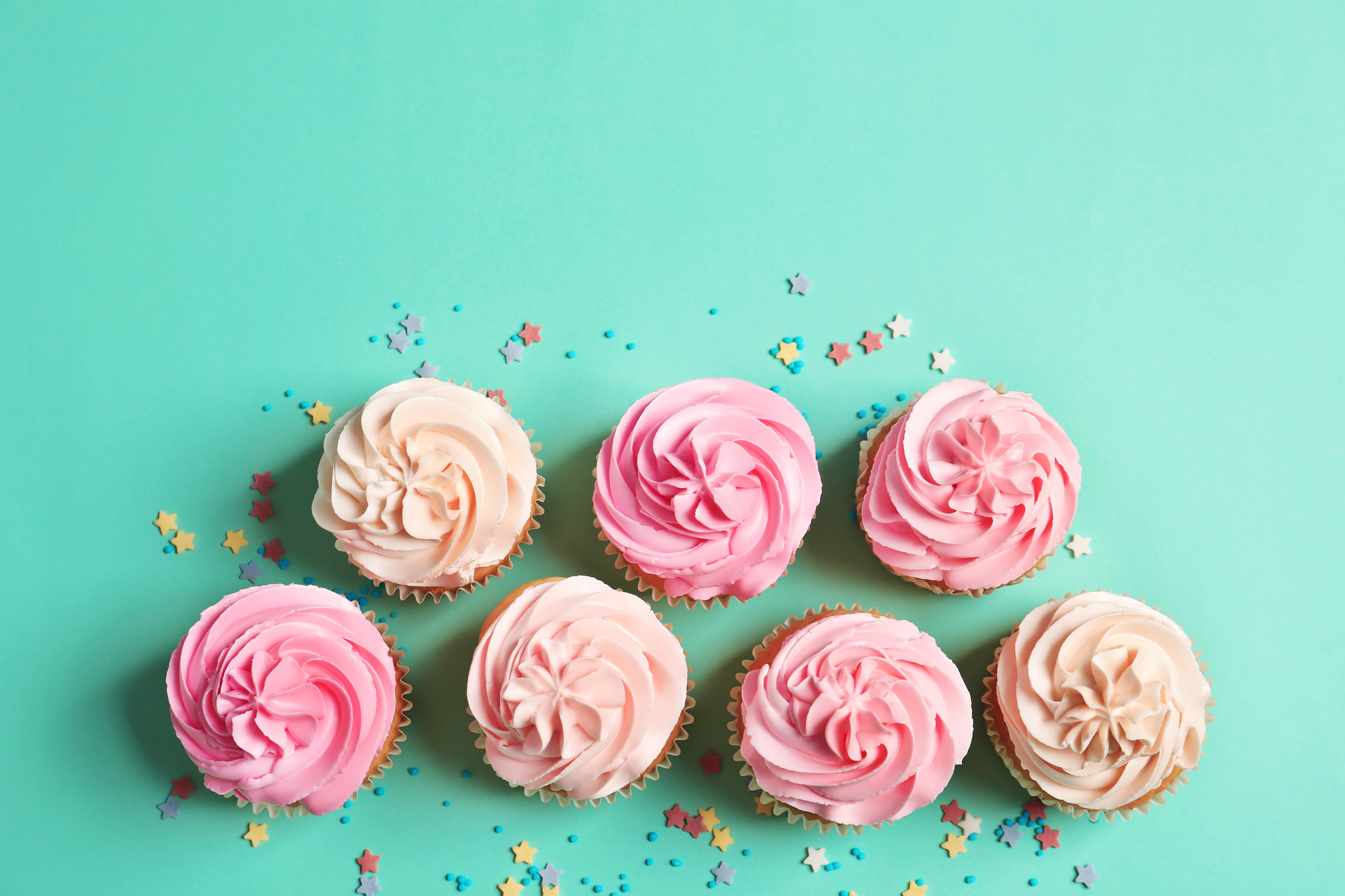Many Yummy Cupcakes on Color Background